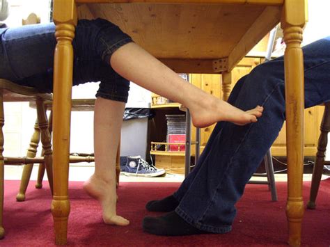 footjob under a table